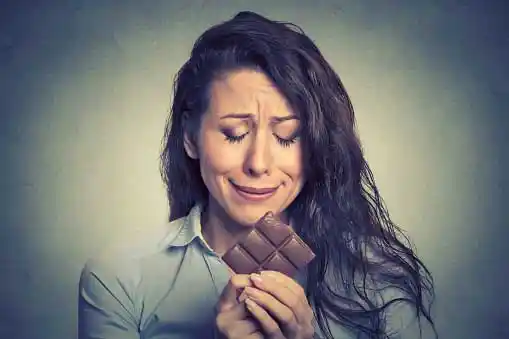  preganant woman cravingly looking at chocolate =